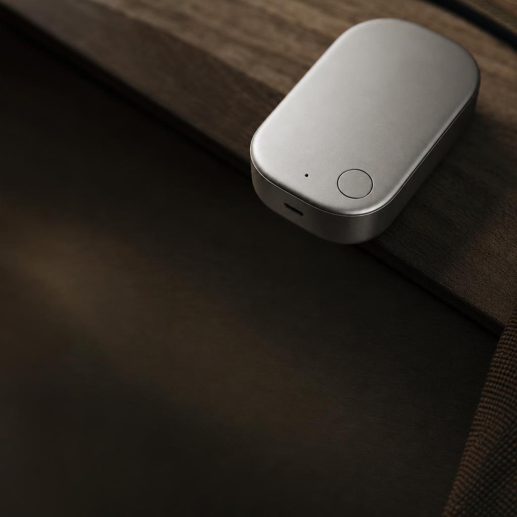 The device on its magnetic dock under soft light